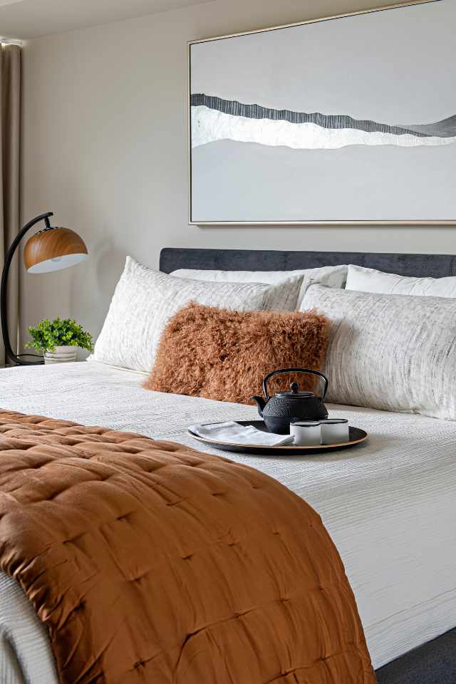 earth toned bedroom with plush duvet and natural ambience